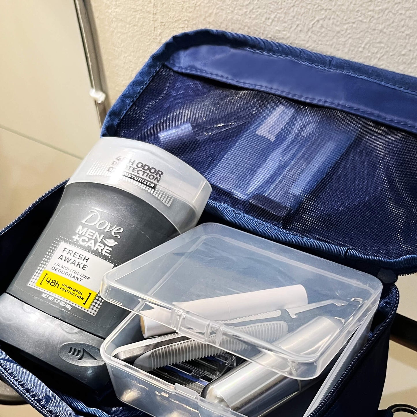 An open navy 190+ Organizer showing toiletries neatly stored inside