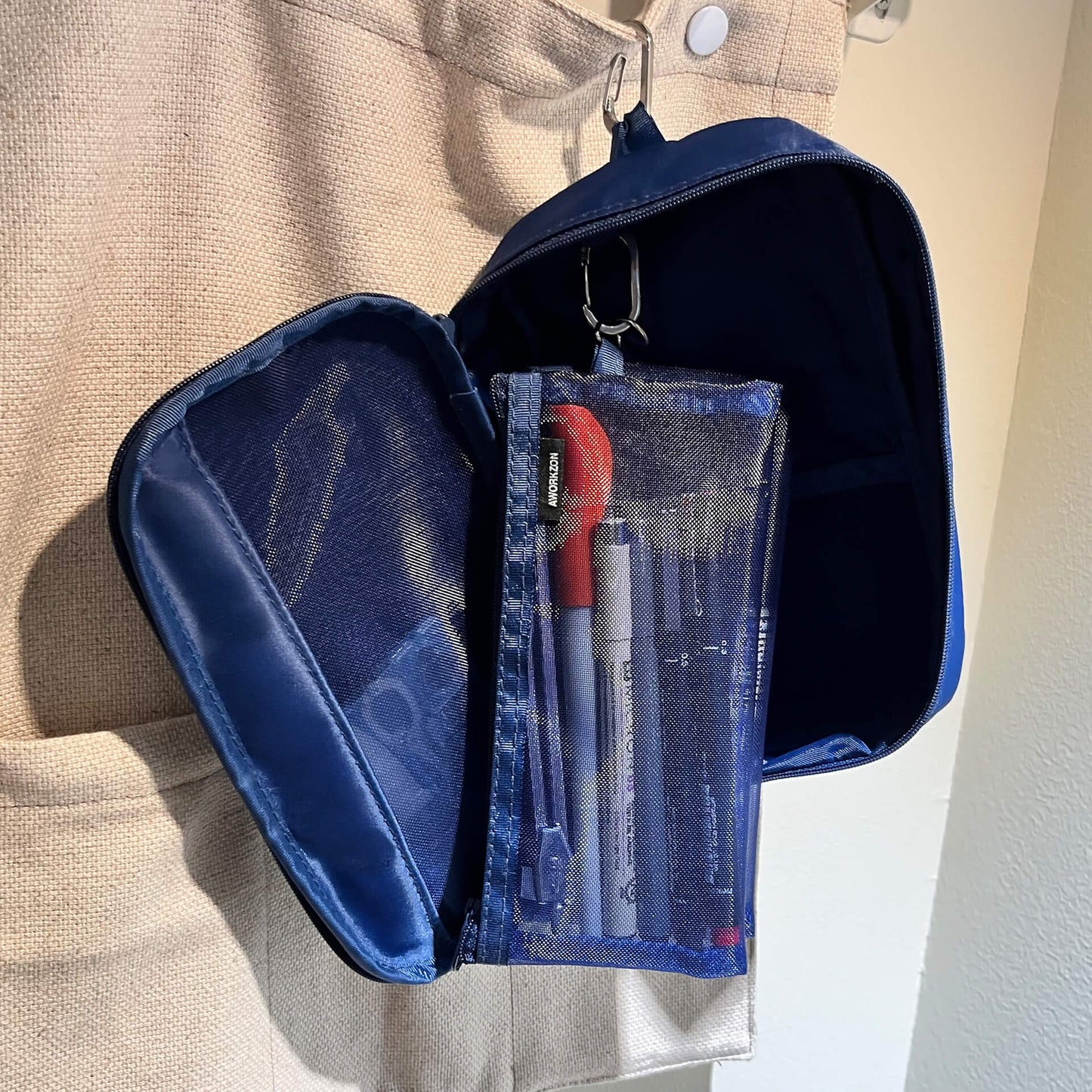 navy 190 organizer hanging on a wall showing a mesh bag inside attached safely