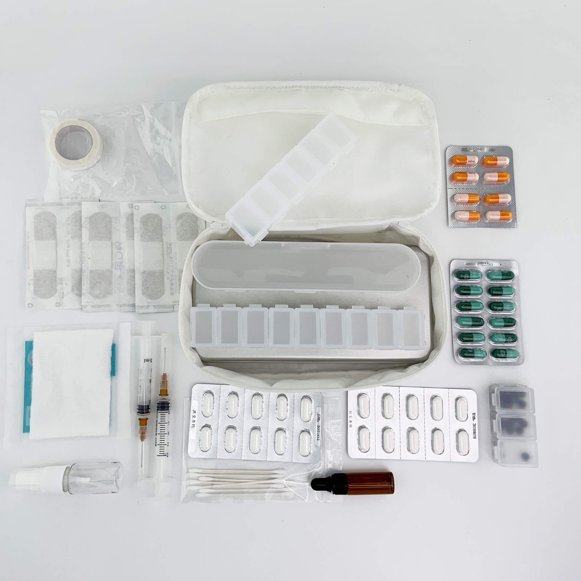 a white 190+ organizer containing various medcine and pill boxes