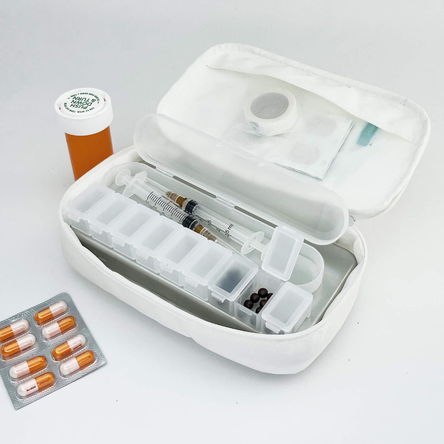 a white 190+ organizer with medcine, pills and pill boxes inside