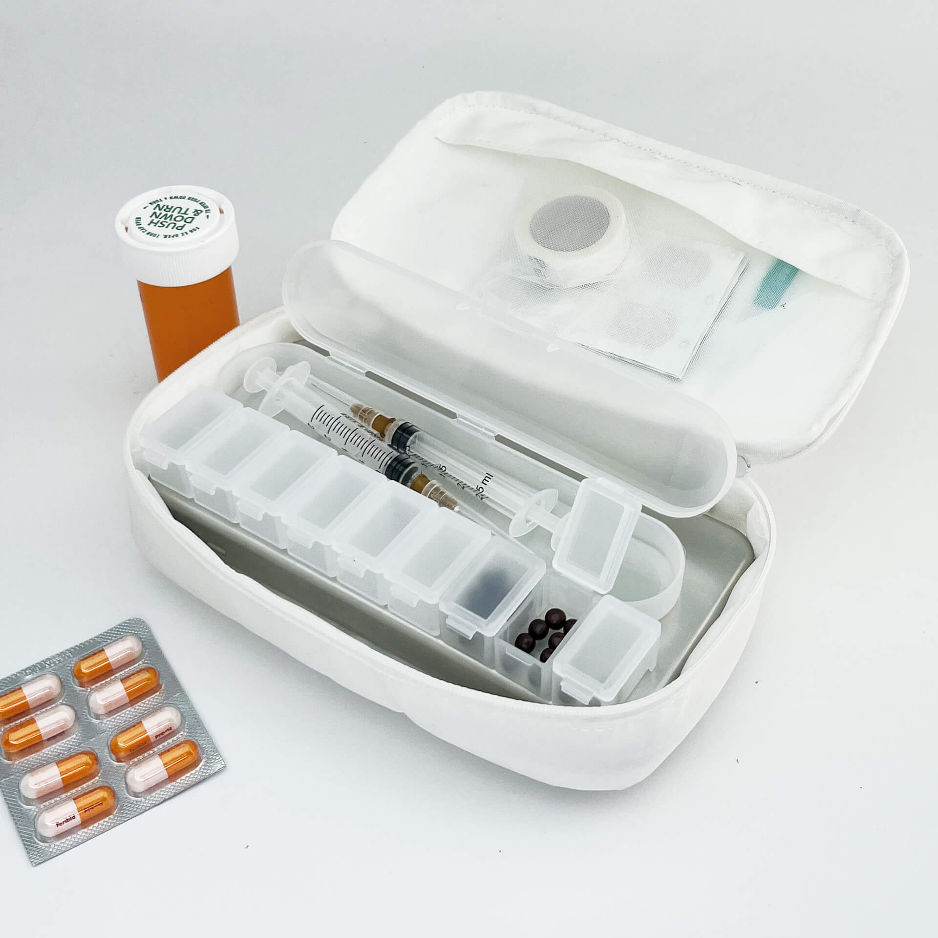 a white 190+ organizer with medcine, pills and pill boxes inside