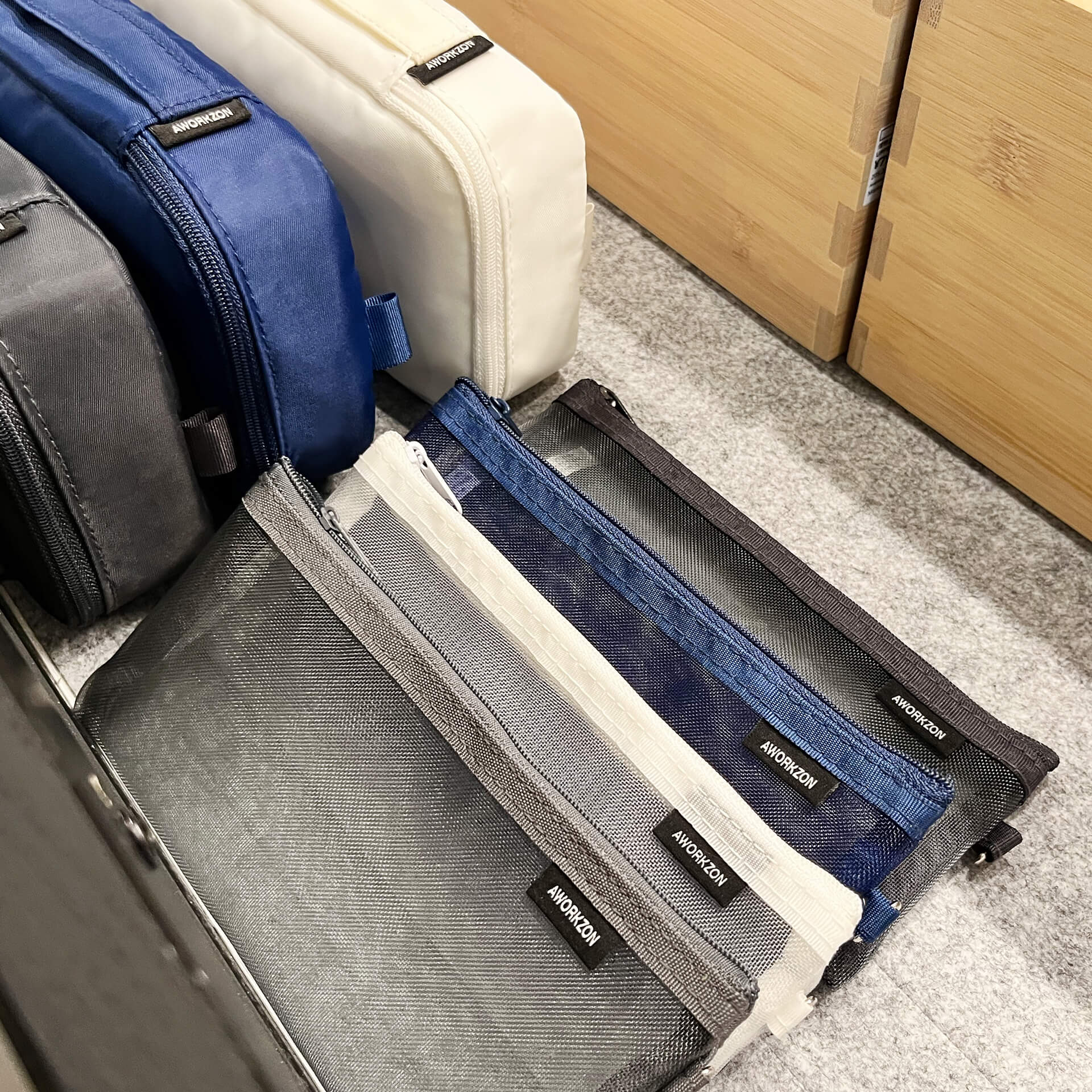Ivory, navy, and charcoal 190+ Organizers with mesh bags neatly arranged inside a drawer