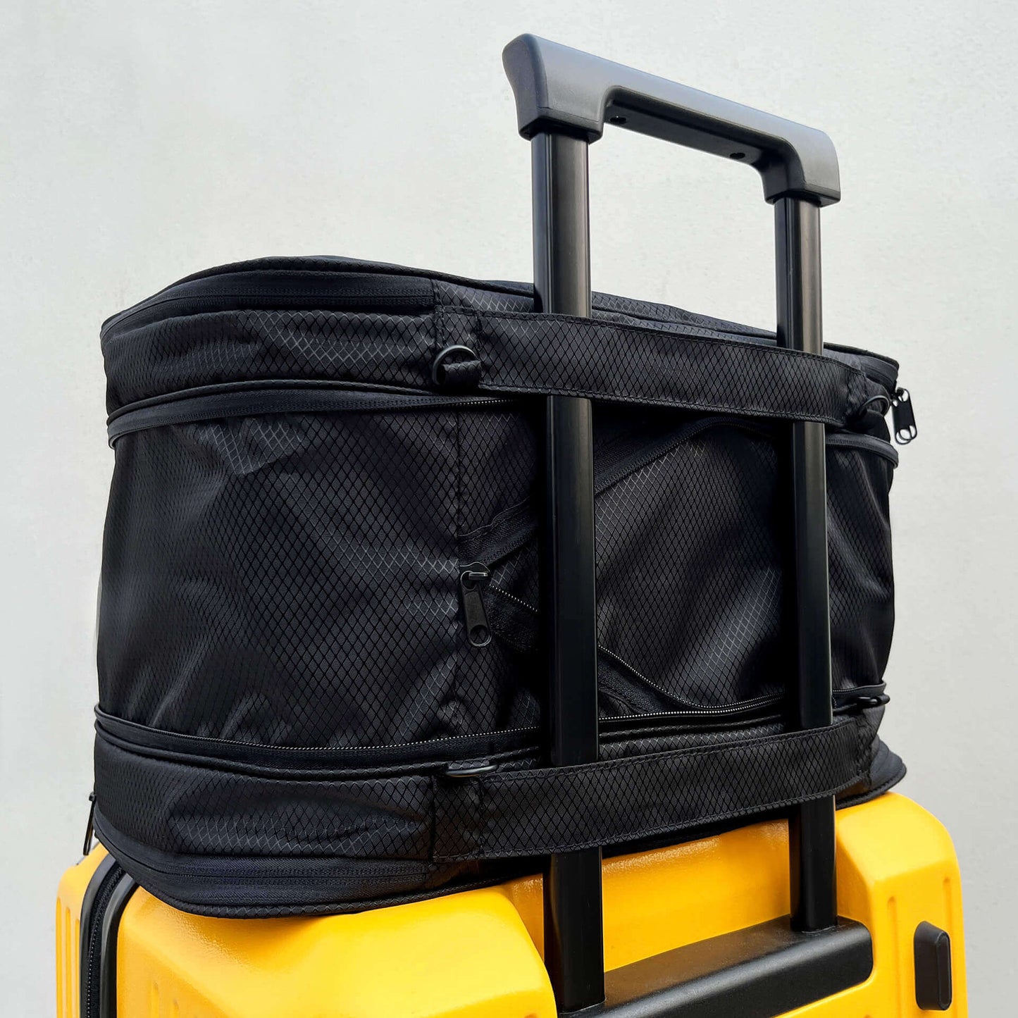 FLEX securely attached to a yellow rolling suitcase
