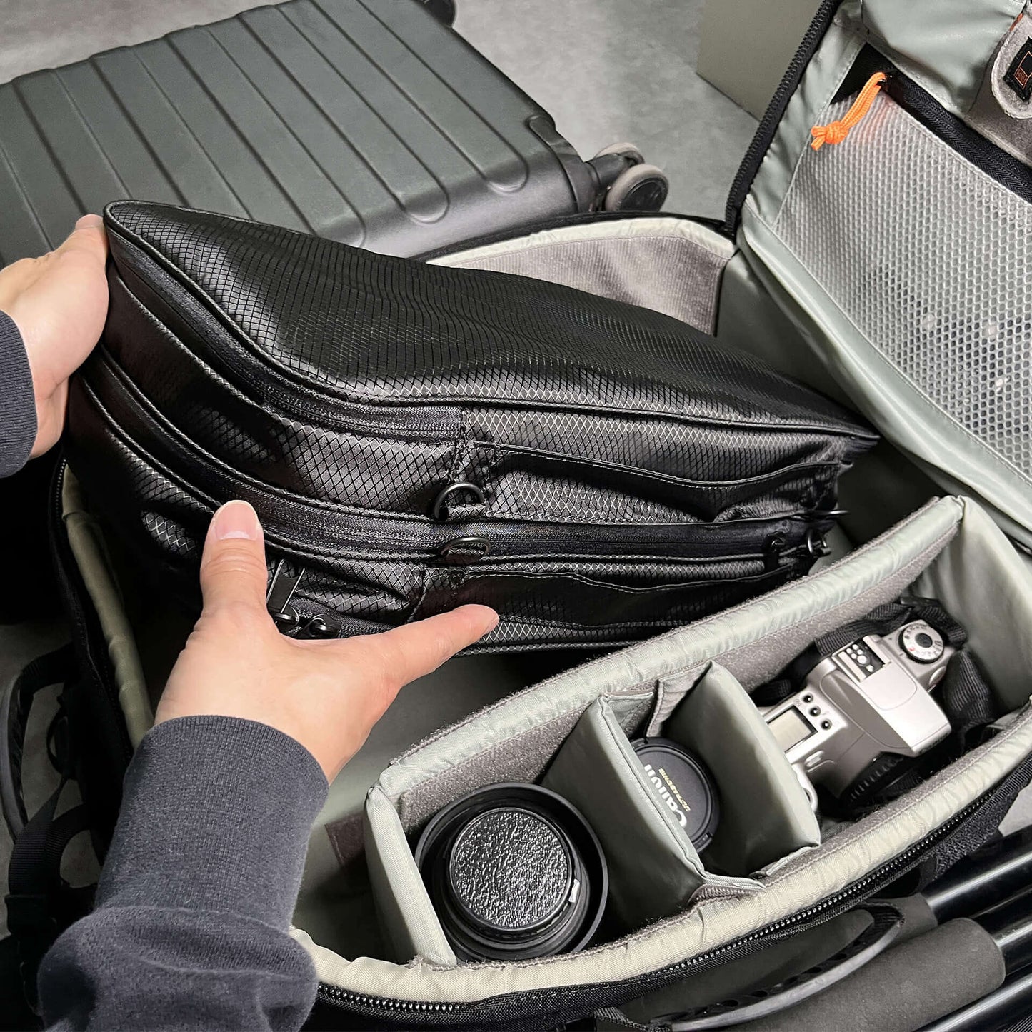 FLEX organizing camera equipment, stored together with lenses and a camera inside a camera bag